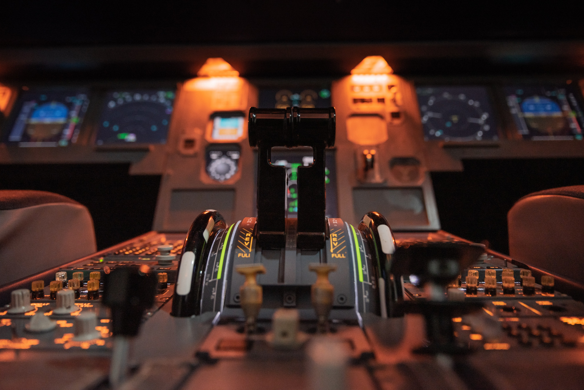 A picture of the inside of a plane cockpit at night